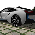 White And Black BMW i8 Sports Car In Outdoor Garden Setting With Greenery