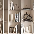 Modern Decorative Ornament Set With Books And Sculptures On Neutral Bookshelf