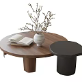 Round Wooden Coffee Table With Open Book White Vase Twigs And Black Side Table