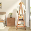 Wooden Clothes Rack in Bedroom with White Garment Shoes Basket Pumpkin and Nightstand Flower Vase