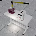 Purple Clamping Device And White Electronic Equipment With Red Wires On White Table Top