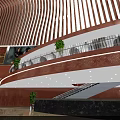 Modern Cinema Interior Design With Multi Level Lobby Glass Railings And Green Plants