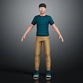 Man Standing in Green Plaid T-Shirt Khaki Pants and Blue Shoes Against Dark Background