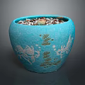 Succulent Plant In Blue Ceramic Pot With Fish And Seaweed Patterns And Small Pebbles