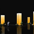 Event Passage In Black Background With Illuminated Yellow Pillars Green Plants And Reflective Floor