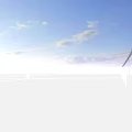 Scenic Offshore Wind Turbines At Sunset With Blue Sky Clouds And Rippling Sea