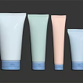 Pastel Colored Cosmetic Tube Containers With Blue Base Caps On Black Reflective Background