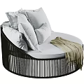 Round Outdoor Sofa with White Pillows Beige Blanket and Black Vertical Striped Frame