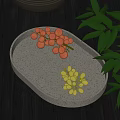 Deep red and light green grapes on oval shallow plate with green leaves beside