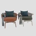 Lounge Chair With Wicker Armrests Orange Cushion Navy Blue Pillow And Striped Throw
