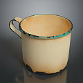 Cream Colored Ceramic Cup With Blue Black Rim Base And Curved Handle