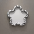 Decorative Flower Shaped Mirror With White Gold Spherical Decorative Frame Reflects Bedroom Interior