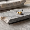 Organic Shape Natural Stone Coffee Table with Black Base Fruit Tray on Gray Living Rug