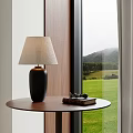 Table Lamp With Light Shade On Wooden Table By Window With Green Lawn Mountain View