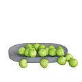 Healthy fresh green fruits placed on and around gray ceramic plate