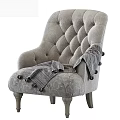Gray Tufted Armchair with Wooden Legs and Striped Throw Blanket with Tassels