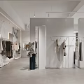 Modern Clothing Store Interior With Hanging Apparel And Minimalist Display Racks
