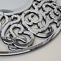 Circular Decorative Mirror with Intricate Metallic Scroll Cutout Design Reflecting Modern Room Interior Elements 3d model