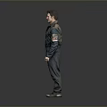Man in Distressed Work Jacket and Torn Pants Standing Against Gray Background