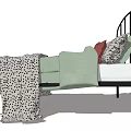 Double Bed With Black Metal Frame Curved Headboard Green Quilt And Leopard Print Blanket