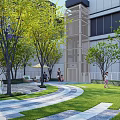 Modern Residential Landscape With Trees Lawn Curved Pathway Building And People Walking