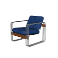Sleek Tubular Metal Leisure Chair With Plush Blue Velvet Cushions And Natural Wood Accent Details