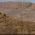 Rugged Desert Scenery With Golden Rock Formations And Sunset Illuminated Valleys