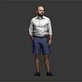 Man Standing with Hands in Pockets Wearing White Shirt and Blue Shorts Against Gray Background