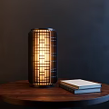 Modern Lattice Design Table Lamp With Warm Light On Wooden Round Table And Books