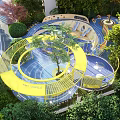Kids Play Area with Circular Blue Flooring Yellow Railings Green Plants and White Spherical Structure