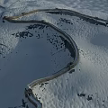 Snow Covered Great Wall With Winding Stone Path In Mountainous Winter Landscape