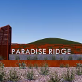 Red Paradise Ridge Feature Wall With Textured Design Surrounding Plants And Green Hills