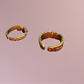 Exquisite Gold Rings With Intricate Carved Patterns On Pastel Pink Background