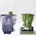Two Transparent Textured Purple And Green Stools With Stacked Books On White Surface