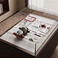 Various Red And White Pipe Fittings With Pressure Gauges In Glass Display Case