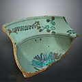 Turquoise Cracked Ceramic Shard Featuring Floral Patterns And Green Plant Motifs