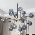 Modern Chandelier With Blue Glass Globes And Golden Metal Frame In Living Room Interior