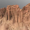 Natural Desert Scenery Featuring Red Rock Formations and Tall Eroded Cliffs