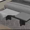 Gray Furry And Padded Bed Footstool Beside White Bed On Geometric Rug Wooden Floor Bedroom
