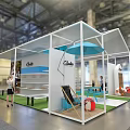 Chusco Exhibition Booth With White Structure Blue Elements Green Lawn And People