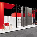 Modern Exhibition Booth With Red Black Frame Gray Concrete Wall White Counter And Bar Stools