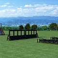 Outdoor Play Equipment on Green Lawn with Black Obstacles and Mountain View under Blue Sky