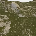 Natural Garden Landscape With Lush Green Grassland And Rocky Hill Terrain