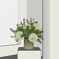 Green Vase With White Hydrangeas And Eucalyptus Leaves On White Table By White Blinds