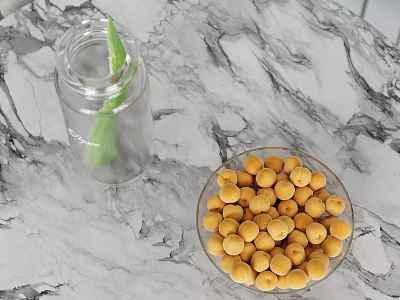 Transparent Glass Bottle With Green Leaf And Bowl Of Yellow Fruits On Marble Tabletop 3d model