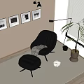 Stylish Black Chaise Lounge in Living Room with Framed Pictures Floor Lamp and Potted Plant