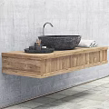 Black Stone Sink with Silver Faucet on Wooden Countertop and Stone Containers Against Gray Wall