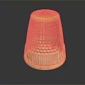 Golden Metallic Thimble Sculpture With Intricate Diamond Patterns And Base Stripes On Reflective Surface