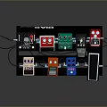 Guitar Effects Pedals In Various Colors Arranged On Black Pedalboard With Cables