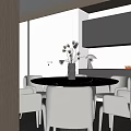 Modern Minimalist Restaurant Interior With Round Dining Table Vase Flowers Lamp And Dark Cabinets